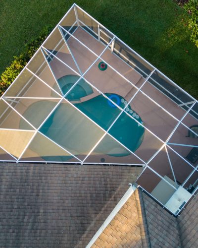 Aerial view of pool screen enclosure surrounded by trees