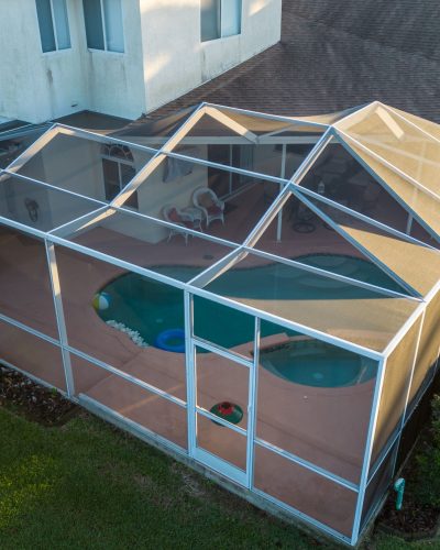 Aerial view of pool screen enclosure surrounded by trees